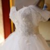 1618912027399.jpg The Bride'S Wedding Dress With Long Tail In Front Of The Studio