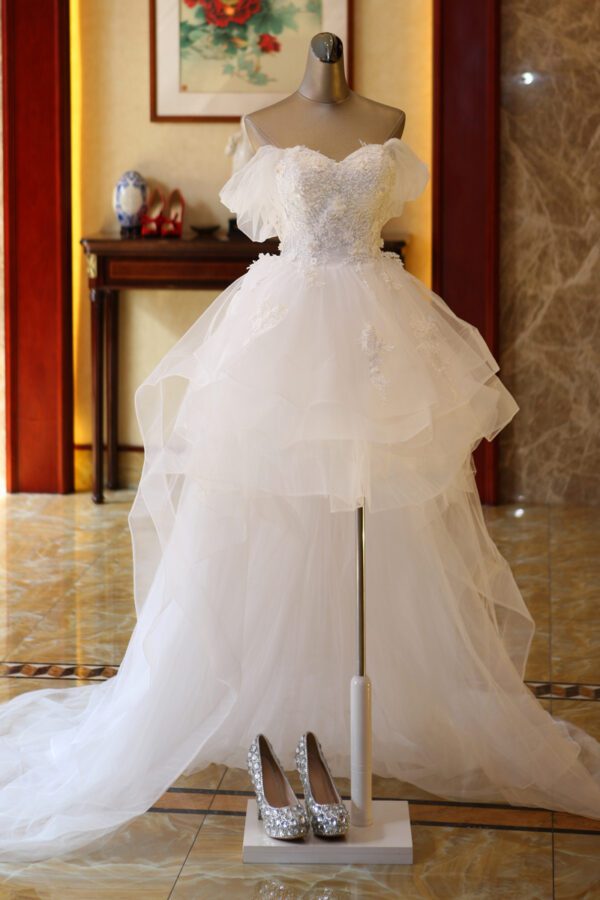 1618912027400.jpg The Bride'S Wedding Dress With Long Tail In Front Of The Studio