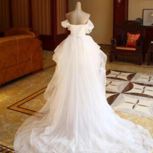 591e4eae-1cb9-420c-9f9b-7670e3bcd3bb.jpg The Bride'S Wedding Dress With Long Tail In Front Of The Studio